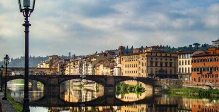 A breathtaking view of Florence's architecture reflecting in the river at dusk, capturing the vibrant essence of Italy.