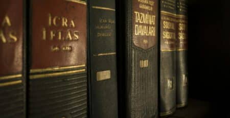 Detailed close-up of law and regulation books on a bookshelf, emphasizing education and knowledge.