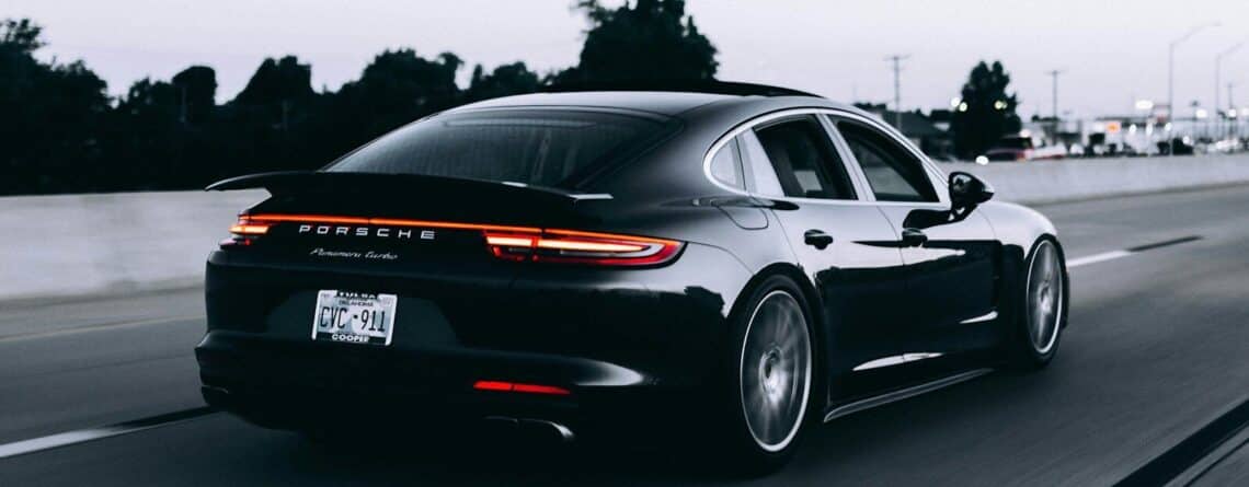 running black Porsche sedan